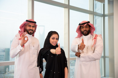 رجال اعمال سعوديون عرب وسيدة اعمال ، ناجحون و سعداء ، بأصبع ابهام للأعلى