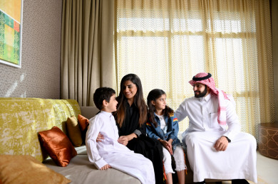 عائلة سعودية سعيدة  مجتمعة في غرفة المعيشة